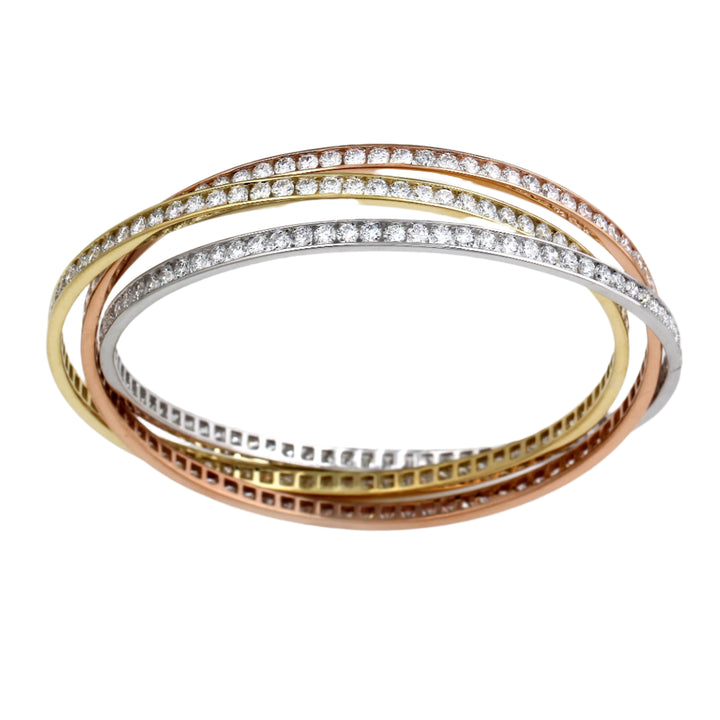 A tri-color gold bracelet featuring intertwined bangles with lab-created diamonds, positioned on a white background.